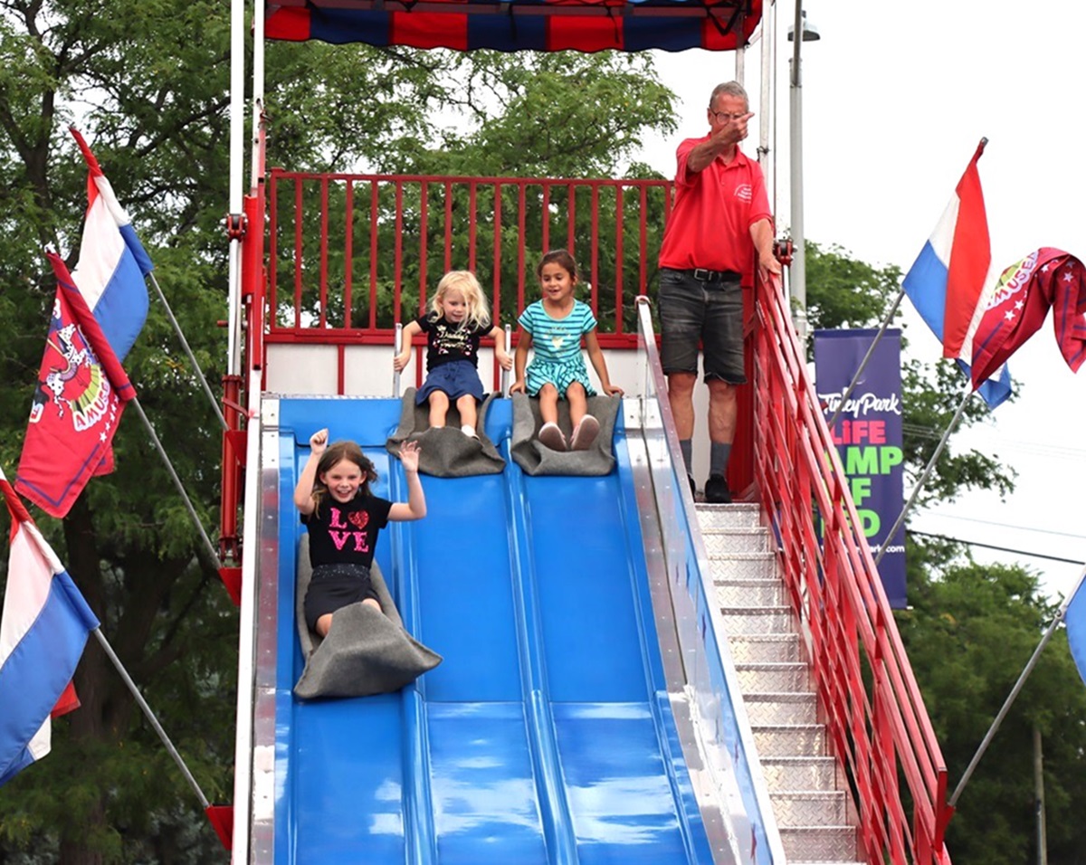 Kids sliding down a Giant Slide ride